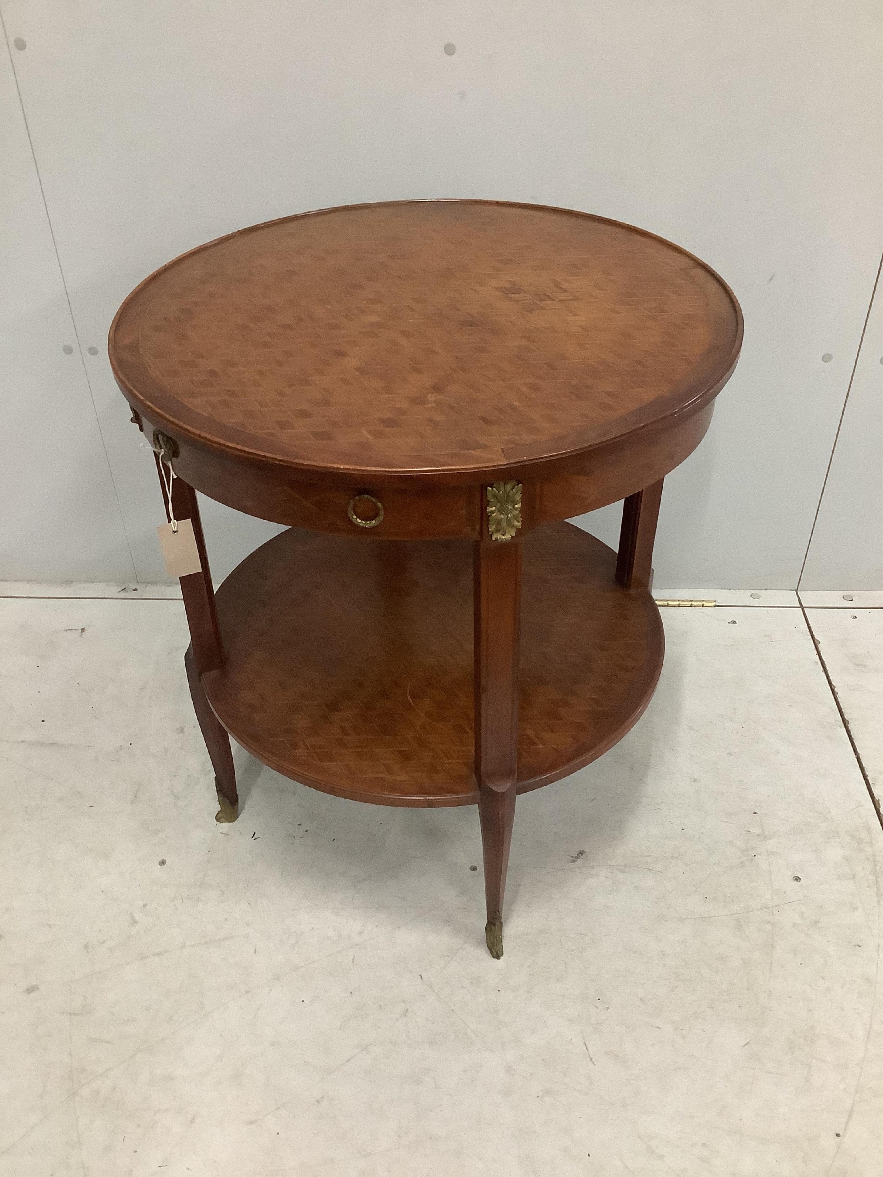 A French transitional style gilt metal mounted circular two tier occasional table, diameter 66cm, height 75cm. Condition - fair